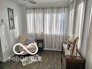 sitting room featuring crown molding, dark hardwood / wood-style flooring, and a healthy amount of sunlight