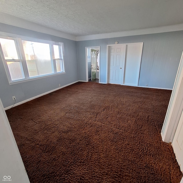 unfurnished bedroom featuring dark carpet and a textured ceiling