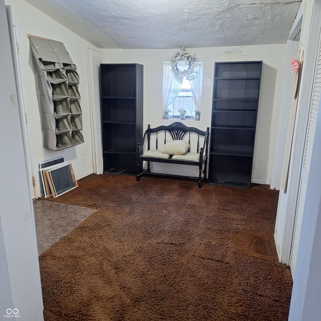 living area featuring dark colored carpet, a textured ceiling, a chandelier, and heating unit