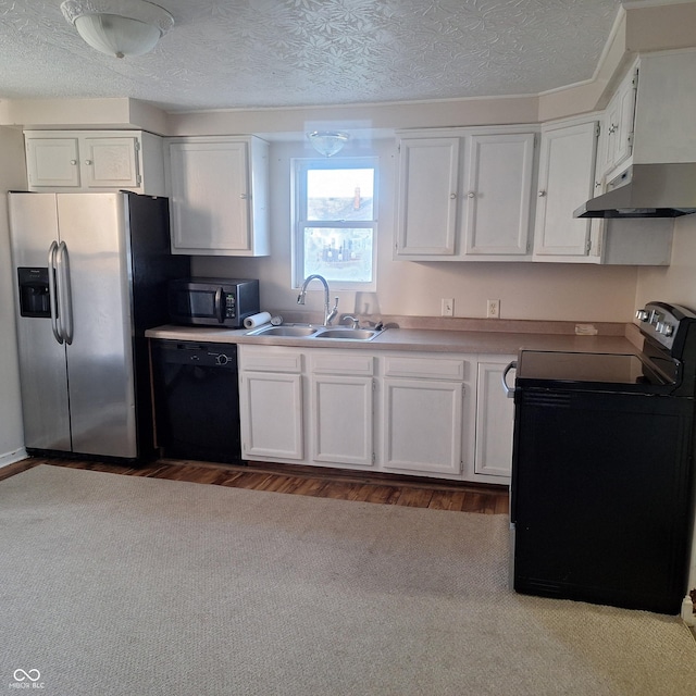 kitchen with white cabinetry, sink, black appliances, and a textured ceiling