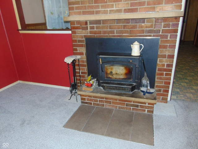 room details featuring a wood stove and carpet floors