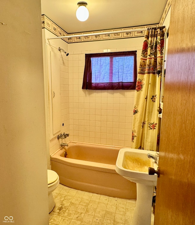 bathroom featuring shower / bath combination with curtain and toilet