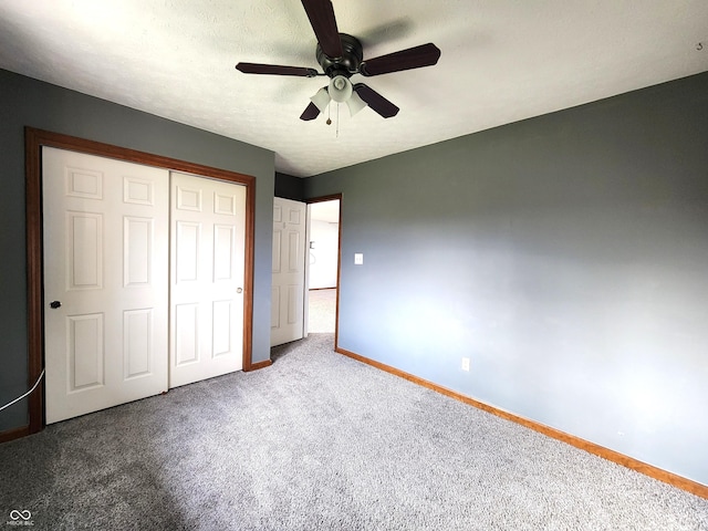 unfurnished bedroom with carpet, ceiling fan, and a closet