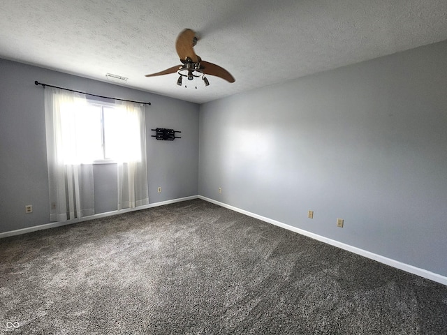 carpeted spare room with a textured ceiling and ceiling fan