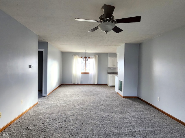 unfurnished living room with ceiling fan, light carpet, and a textured ceiling