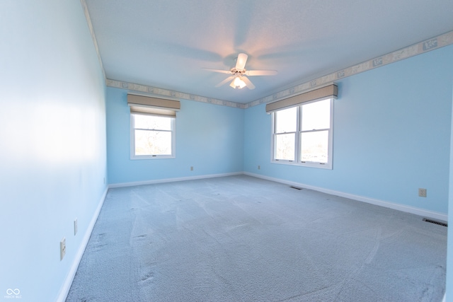 unfurnished room with ceiling fan and carpet floors