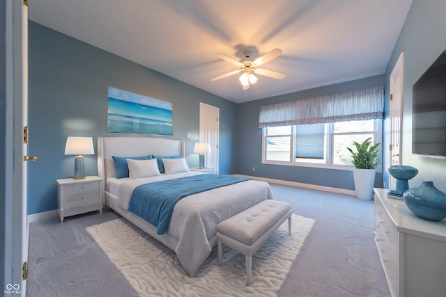 bedroom with ceiling fan and light carpet