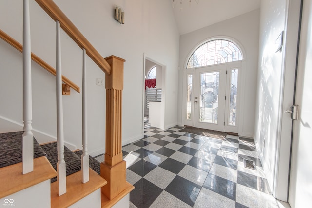 entryway featuring high vaulted ceiling