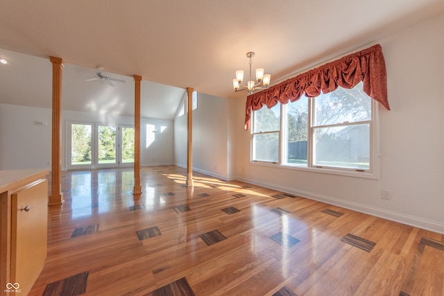 interior space featuring hardwood / wood-style floors and ceiling fan with notable chandelier