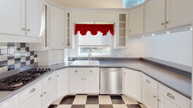 kitchen featuring backsplash, sink, white cabinets, and appliances with stainless steel finishes