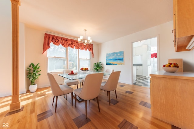 dining room featuring an inviting chandelier and light wood-type flooring