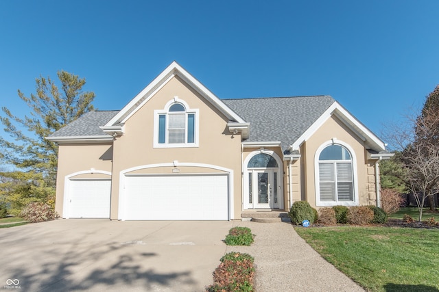 view of front property featuring a front yard and a garage