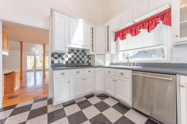 kitchen with backsplash, white cabinetry, sink, and stainless steel appliances