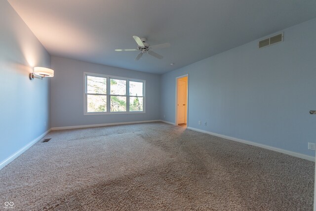 spare room with carpet flooring and ceiling fan