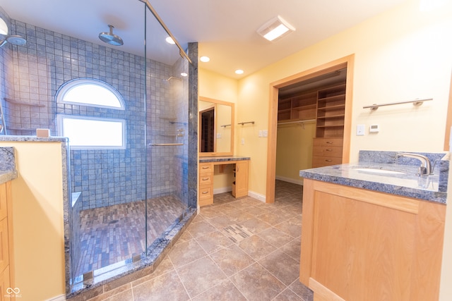 bathroom featuring tile patterned flooring, vanity, and an enclosed shower