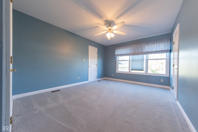 carpeted empty room with ceiling fan