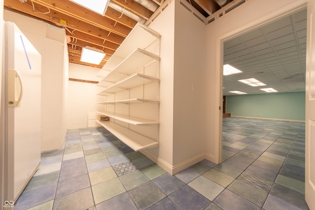 interior space featuring tile patterned floors and white fridge