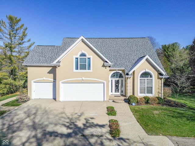 view of front of house with a front yard and a garage