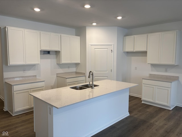 kitchen featuring white cabinets, a center island with sink, and sink