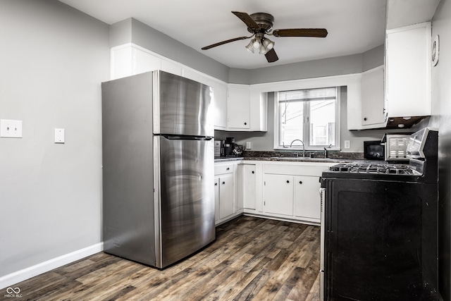 kitchen featuring dark hardwood / wood-style flooring, black range with gas stovetop, sink, white cabinetry, and stainless steel refrigerator