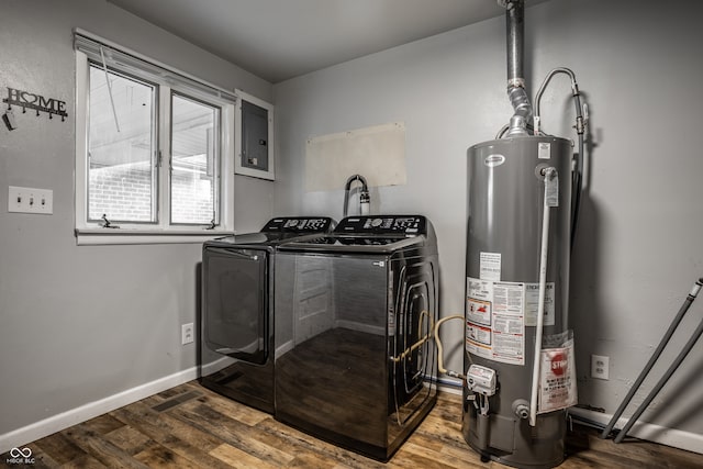 washroom featuring dark hardwood / wood-style flooring, water heater, washer and clothes dryer, and electric panel