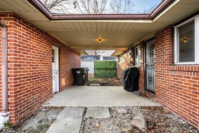 view of patio / terrace with area for grilling and a carport