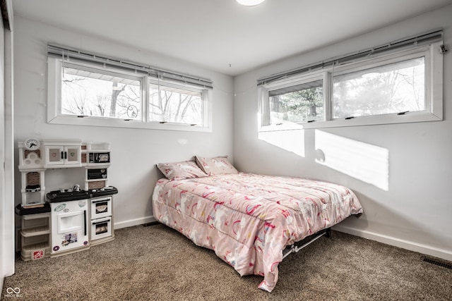 carpeted bedroom featuring multiple windows