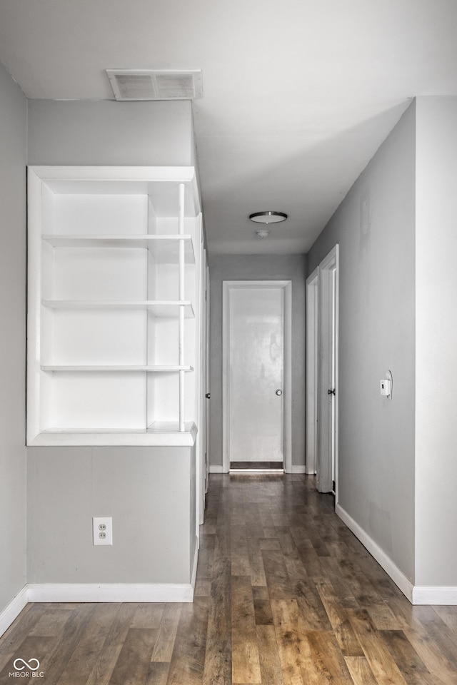 corridor featuring dark hardwood / wood-style floors