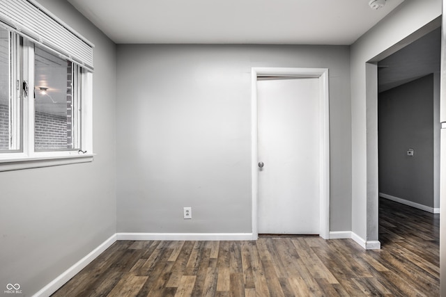 unfurnished bedroom featuring dark hardwood / wood-style flooring