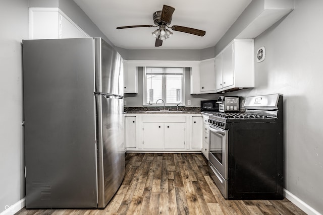 kitchen with sink, dark hardwood / wood-style flooring, white cabinets, and appliances with stainless steel finishes