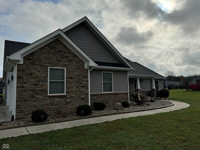 view of side of property featuring a garage and a yard