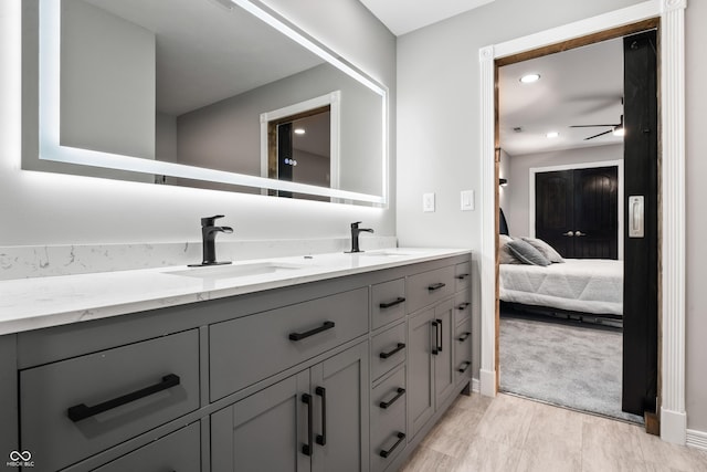 9462 N Rushville Rd, Knightstown, IN 46148 - bathroom with double vanity, a ceiling fan, ensuite bath, baseboards, and recessed lighting