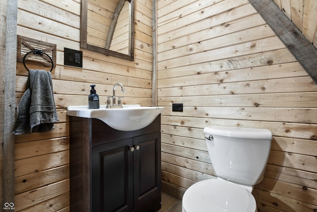 9462 N Rushville Rd, Knightstown, IN 46148 - bathroom with wood walls, toilet, vanity, and wood finished floors