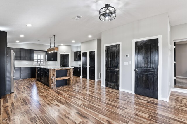 9462 N Rushville Rd, Knightstown, IN 46148 - kitchen with freestanding refrigerator, wood finished floors, open shelves, dark cabinets, and vaulted ceiling