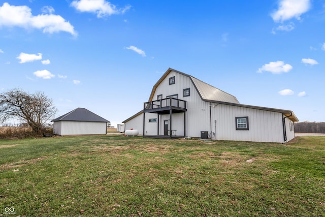 9462 N Rushville Rd, Knightstown, IN 46148 - rear view of property with a gambrel roof, a yard, an outdoor structure, and central AC unit
