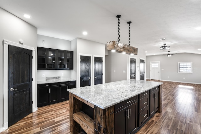 9462 N Rushville Rd, Knightstown, IN 46148 - kitchen with wood finished floors, a ceiling fan, open shelves, glass insert cabinets, and lofted ceiling