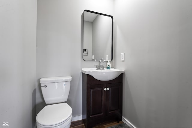 bathroom with vanity, wood-type flooring, and toilet