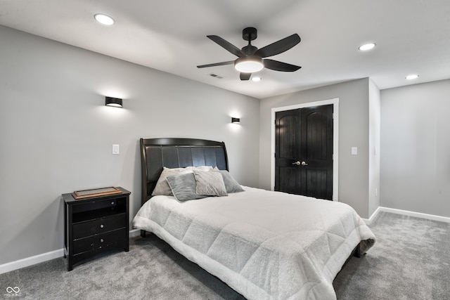 carpeted bedroom featuring ceiling fan and a closet