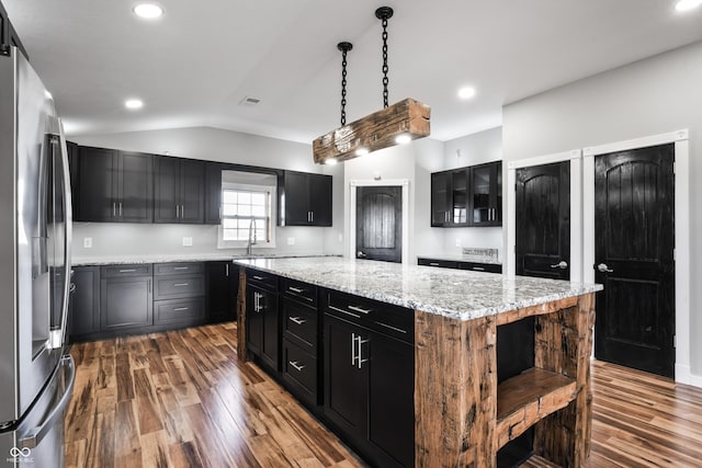 9462 N Rushville Rd, Knightstown, IN 46148 - kitchen with freestanding refrigerator, a kitchen island, vaulted ceiling, dark wood finished floors, and dark cabinetry