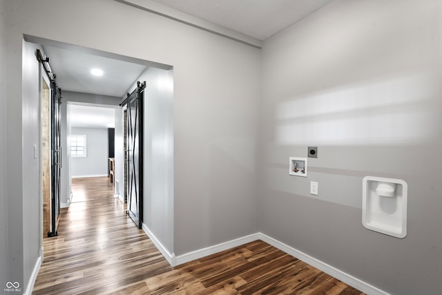 9462 N Rushville Rd, Knightstown, IN 46148 - corridor featuring a barn door, dark wood-type flooring, and baseboards