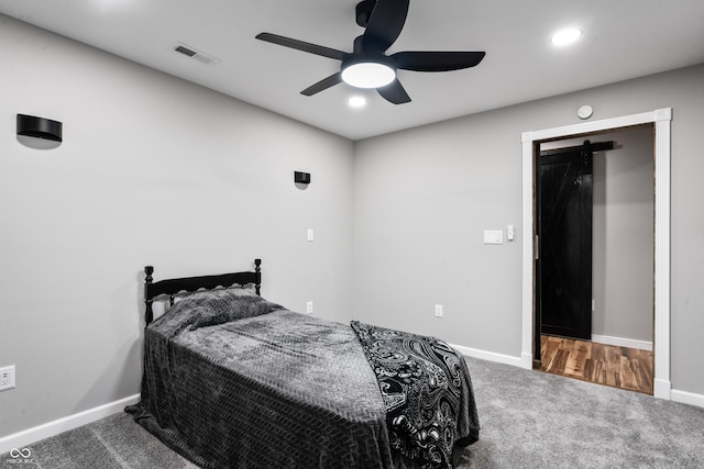 9462 N Rushville Rd, Knightstown, IN 46148 - bedroom with carpet flooring, baseboards, a barn door, and recessed lighting