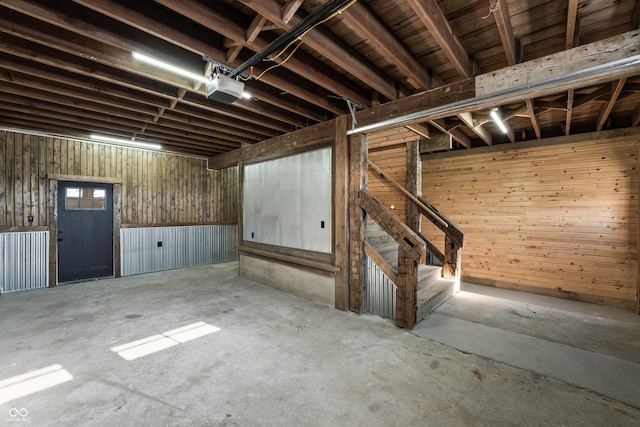 basement featuring wood walls