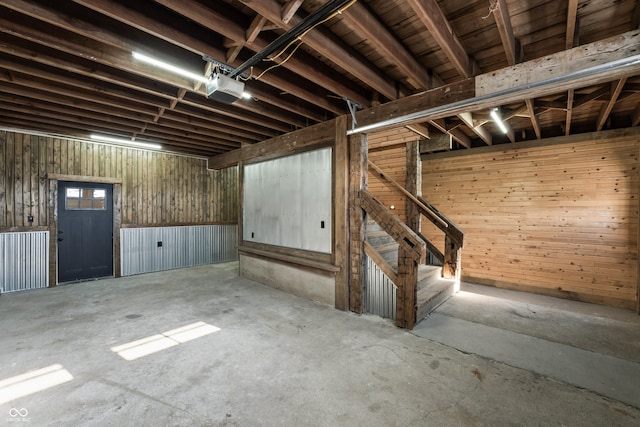 9462 N Rushville Rd, Knightstown, IN 46148 - below grade area featuring a garage, wood walls, and stairway