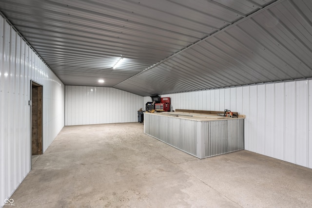 bonus room with concrete flooring and lofted ceiling