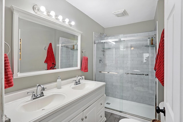 bathroom featuring vanity and a shower with shower door