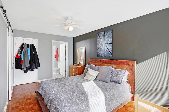 bedroom with ceiling fan, parquet flooring, ensuite bathroom, and a closet