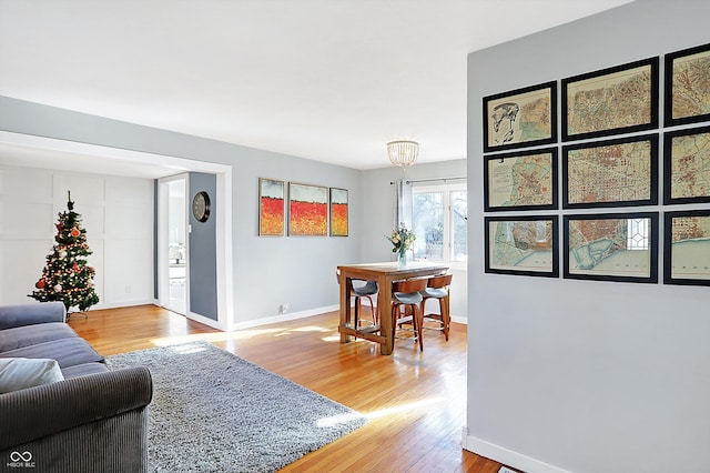 living room featuring a notable chandelier and wood-type flooring