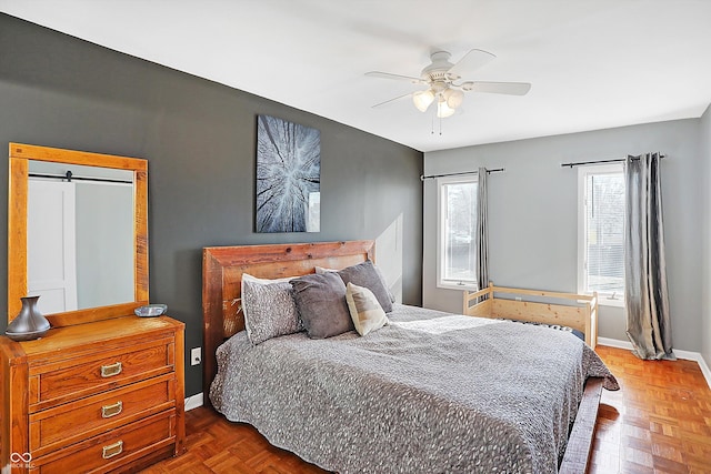 bedroom featuring ceiling fan and parquet flooring