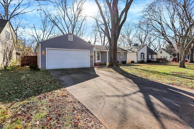 ranch-style home featuring a garage and a front lawn