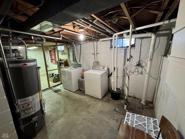 basement with gas water heater and washer and clothes dryer